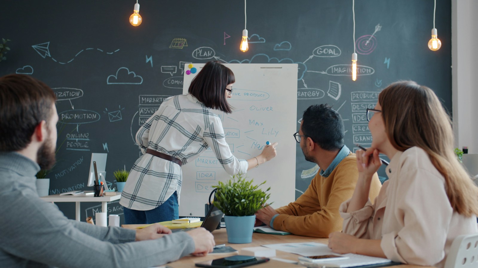 Engineers working through a spec together at a whiteboard